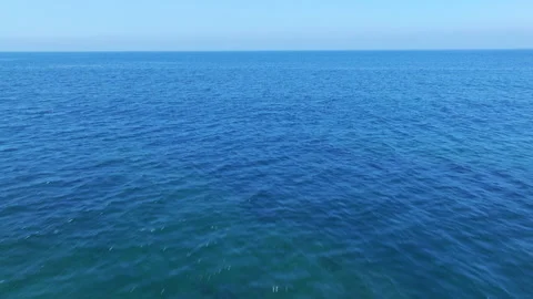 Aerial view of blue ocean under blue sky Stock Footage 338147061
