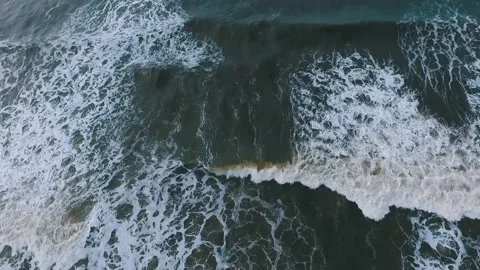 Aerial View of blue ocean waves breaking, foaming and crashing Stock Footage 148699571