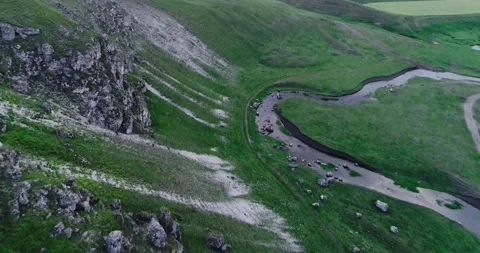 Aerial view of a blue river situated in between two enormous hills. Stock Footage 135029326