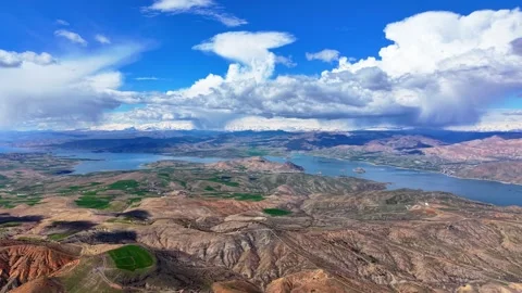 Aerial View of a Blue River Valley with Distant Snow Capped Mountains Stock-Footage 342001806