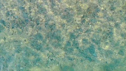 Aerial view of blue sea surface on sand beach with light reflections. Stock Footage 108008000