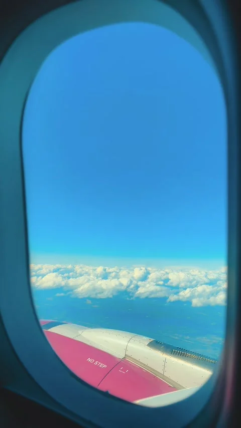 Aerial view of blue sky with fluffy white clouds from airplane window coming in Stock Footage 346296819