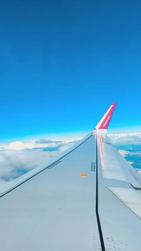 Aerial view of blue sky with fluffy white clouds from airplane window coming in Stock Footage 346296828