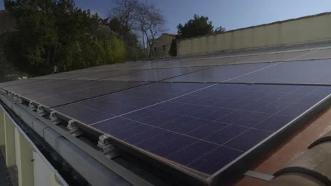 Aerial view of blue solar panels on a flat roof. Symmetrical photovoltaic Stock Footage 335347492