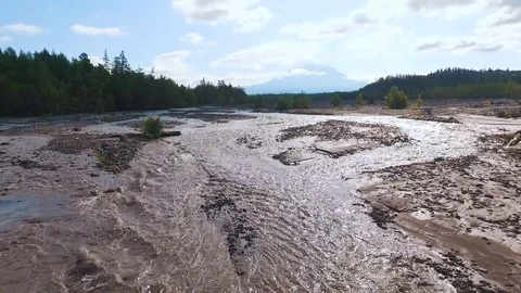 Aerial view. Blurred river in the mountains. The road was washed with water Stock Footage 73527633
