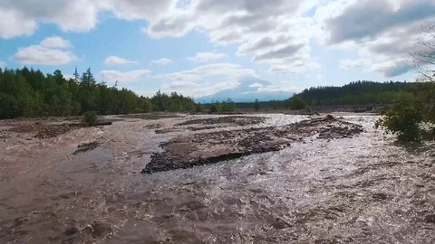 Aerial view. Blurred river in the mountains. The road was washed with water Stock Footage 73528016