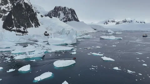 Aerial view of a boat exploring glacial arctic waters Stock Footage 320669485