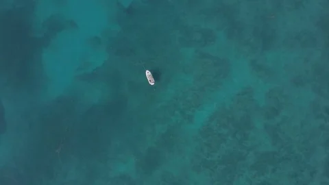 Aerial View of a Boat Floating in a Clear Atlantic Ocean Video stock 79447036