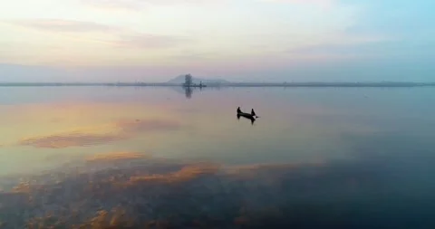 Aerial view of a boat floating on Dal Lake during golden hour with still Stock Footage 310656529
