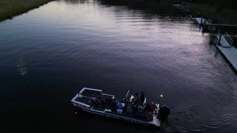 Aerial view of a boat heading out onto the Potomac River at dusk Stock Footage 345299936