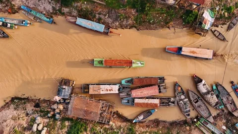 Aerial view of a boat navigating the river of kampong phluk, a traditional Stock-Footage 322521637