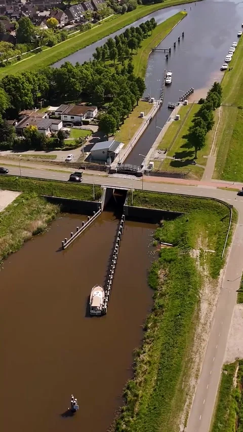 Aerial view of a boat navigating through a canal lock Stock Footage 327109473