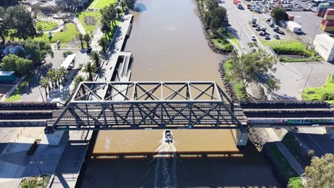 Aerial view of a boat passing under a railway bridge over a river Stock-Footage 340513296