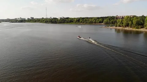 Aerial View of a Boat Pulling a Wakeboarder on a shipping dock Omsk Irtysh Stock Footage 237820413