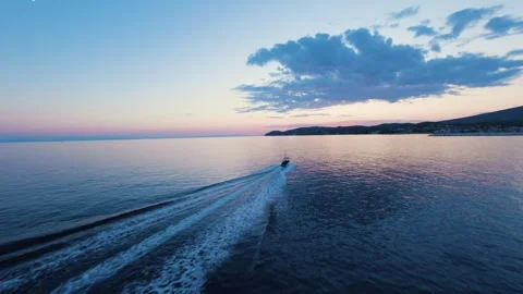 Aerial view of boat returning to harbor during sunset Stock Footage 328192553