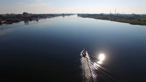 Aerial View Of Boat On a River Going Towards the Sun Stock Footage 68411273
