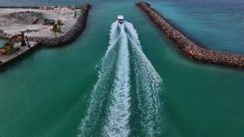 Aerial view of boat sailing between rock walls, Maldives. Stock Footage 316586917