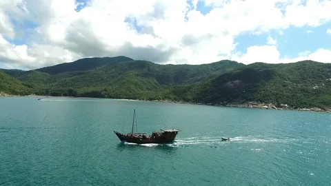 Aerial View: Boat with Tourists Sailing in Sea Near Tropical Island Stock Footage