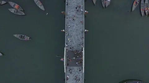 Aerial view. Boats float on river under bridge,  Hoi An old town, Vietnam. Stock Footage 128365418