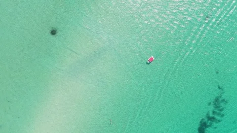 Aerial view of boats floating and moving over clear turquoise waters near Stock Footage 346700566