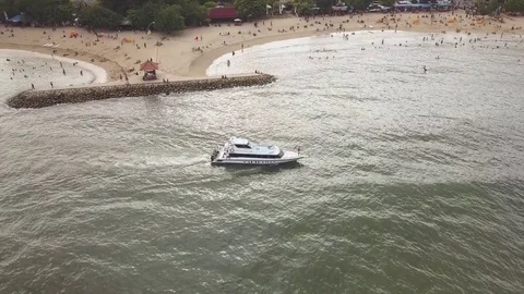 Aerial view boats moving out slowly from sanur beach Stock Footage