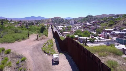 Aerial view of border wall separating united states and mexico with patrol .. Stock Footage 337754445