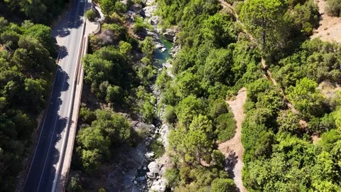 Aerial view of boulder strewn river gorge with hiking trail, Benahavis, Spain Stock Footage 339579743