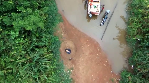 Aerial view boys washing cars in stream Stock Footage