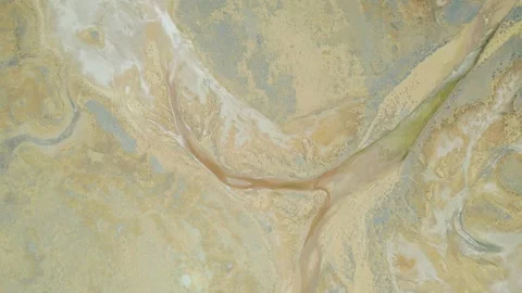 Aerial View Of Braided River Channels And Dry Riverbed Patterns Across Arid Stock Footage 342315893