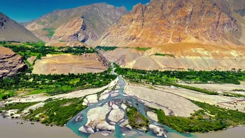Aerial view of braided river delta flowing into larger channel amidst arid Stock Footage 343695916