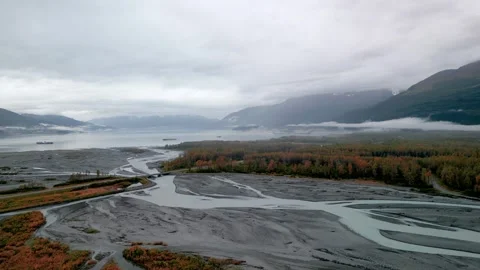 Aerial view of a braided river flowing into a bay in Alaska Stock Footage 333602405