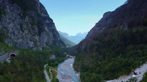 Aerial view of braided river flowing through steep mountainous valley Video stock 342500280