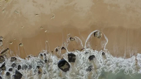 Aerial View Of Breaking Waves About Stones On The Beach Shore Stock Footage 128836184