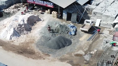 Aerial view of a brick making factory with workers looking at piles of proc.. Stock Footage 312299059