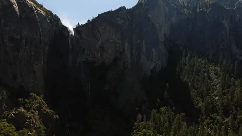 Aerial View of Bridalveil Fall Cascading Down Granite Cliff in Yosemite Stock Footage 319459761