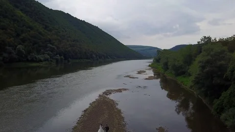 Aerial view, bride and groom, the river on the mountain in the Carpathians Stock Footage 125324924