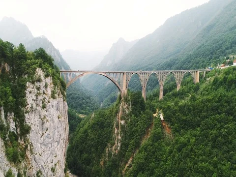 Aerial view of bridge across a river in the mountains 스톡 동영상 80249082