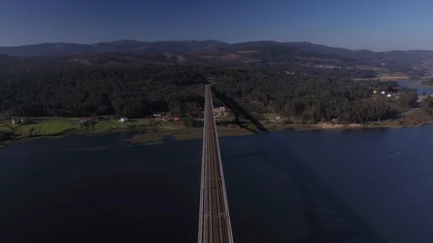 Aerial view of a bridge across the river top view shooting from drone by suns Stock Footage 125267161