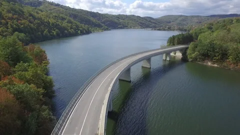 Aerial view of a bridge construction on lake water in countryside aerial shot Stock Footage 146369652