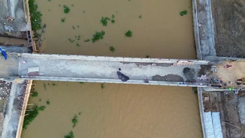 Aerial View of Bridge Construction Over River Stock Footage 325988244