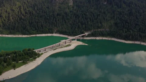Aerial View of Bridge Crossing Emerald Alpine Lake in Austria Stock Footage 340483076