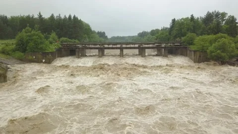 Aerial view of the bridge during floods. Extremely high water level in the river Stock Footage 133606629