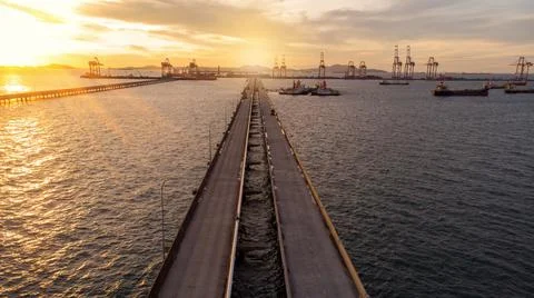 Aerial view of  Bridge for export import cargo to crane at sun set , Bride ro Foto stock