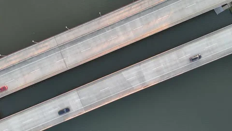 Aerial view of a bridge over a lake or sea with cars driving on it. Stock Footage 336897692