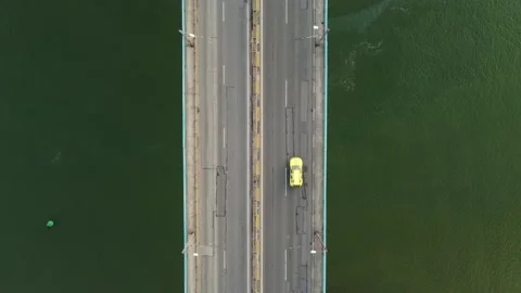 Aerial view of a bridge over a large river with heavy traffic Stock Footage 196988296