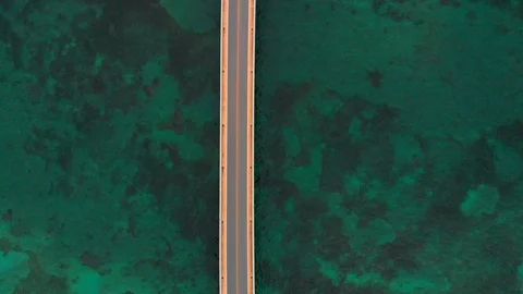 Aerial view of a bridge over the ocean, Miyakojima, Okianwa, Japan. A car Stock Footage 108830860
