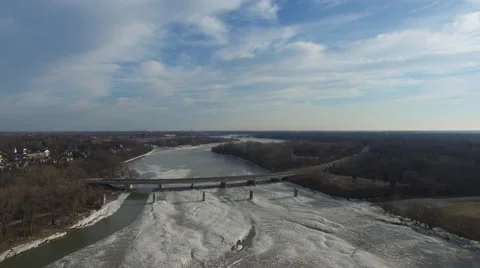 Aerial view of bridge over partially frozen river in Ohio Stock Footage 60022843