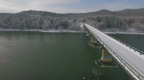 Aerial view of bridge over the river and the road in the winter forest 4K Stock Footage 57252553