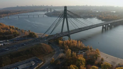 Aerial view of bridge over river Dnipro, Kyiv. Cars crossing water over highway Stock Footage 104845141