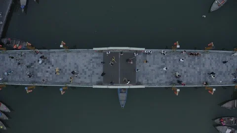 Aerial view of bridge over river, floating boats, tourists. Hoi An town, Vietnam Video stock 128225520
